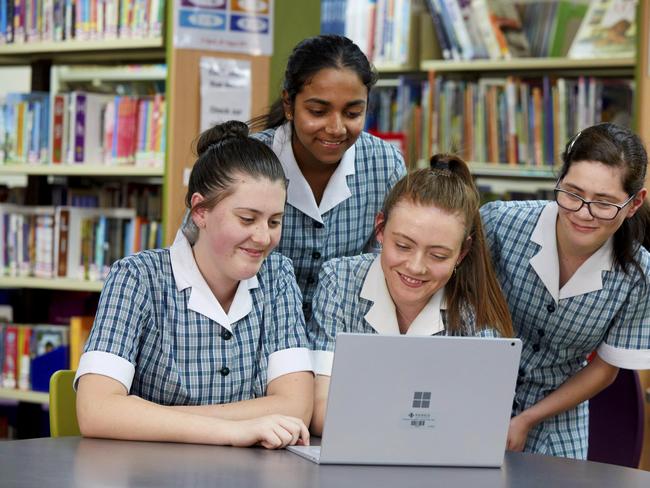 PENRITH PRESS/AAP. (L-R) Montgrove College students Hannah Wilkinson, Malini Perera, Abbie Skene and Gini-Mary McDonald pose for photographs in Orchard Hills on Thursday 5 December, 2019. Montgrove college has been revealed as one of the highest performing schools in NAPLAN in western Sydney. (AAP IMAGE / Angelo Velardo)