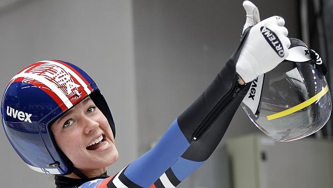 Kate Hansen of the United States smiles in the finish area after her third run during the women's singles luge competition at the 2014 Winter Olympics (AP Photo/Natacha Pisarenko)