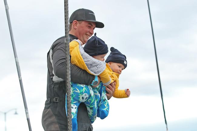 Oliver Burnell with twin nephews Angus and William McCracken, 8 months as Alive claims line honours in the 2020 Launceston to Hobart yacht race. Picture: Zak Simmonds