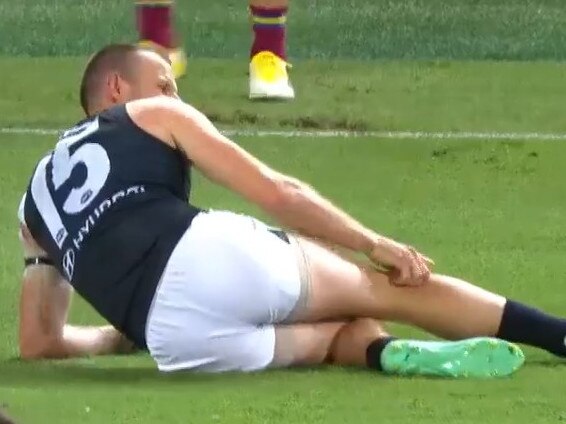 Carlton's Sam Docherty leaves the Gabba with a knee injury in Opening Round after being tackled by Callum Ah Chee.