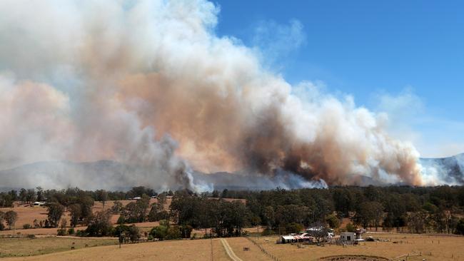 Smoke billows around Hillville as property owners fight to save their homes. Picture: Gary Ramage