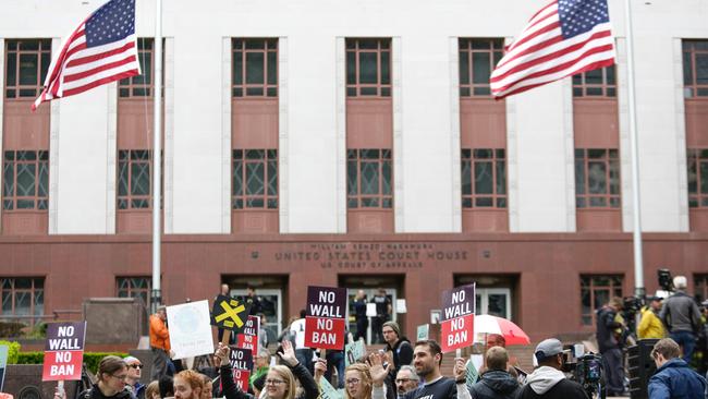 Protesters outside court during the appeal over Donald Trump's travel ban. Picture: Jason Redmond