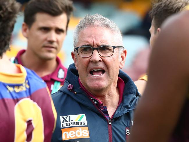 BRISBANE, AUSTRALIA - JUNE 28: Lions coach Chris Fagan talks to his team during the round 4 AFL match between the Brisbane Lions and the Adelaide Crows at The Gabba on June 28, 2020 in Brisbane, Australia. (Photo by Jono Searle/AFL Photos/via Getty Images )