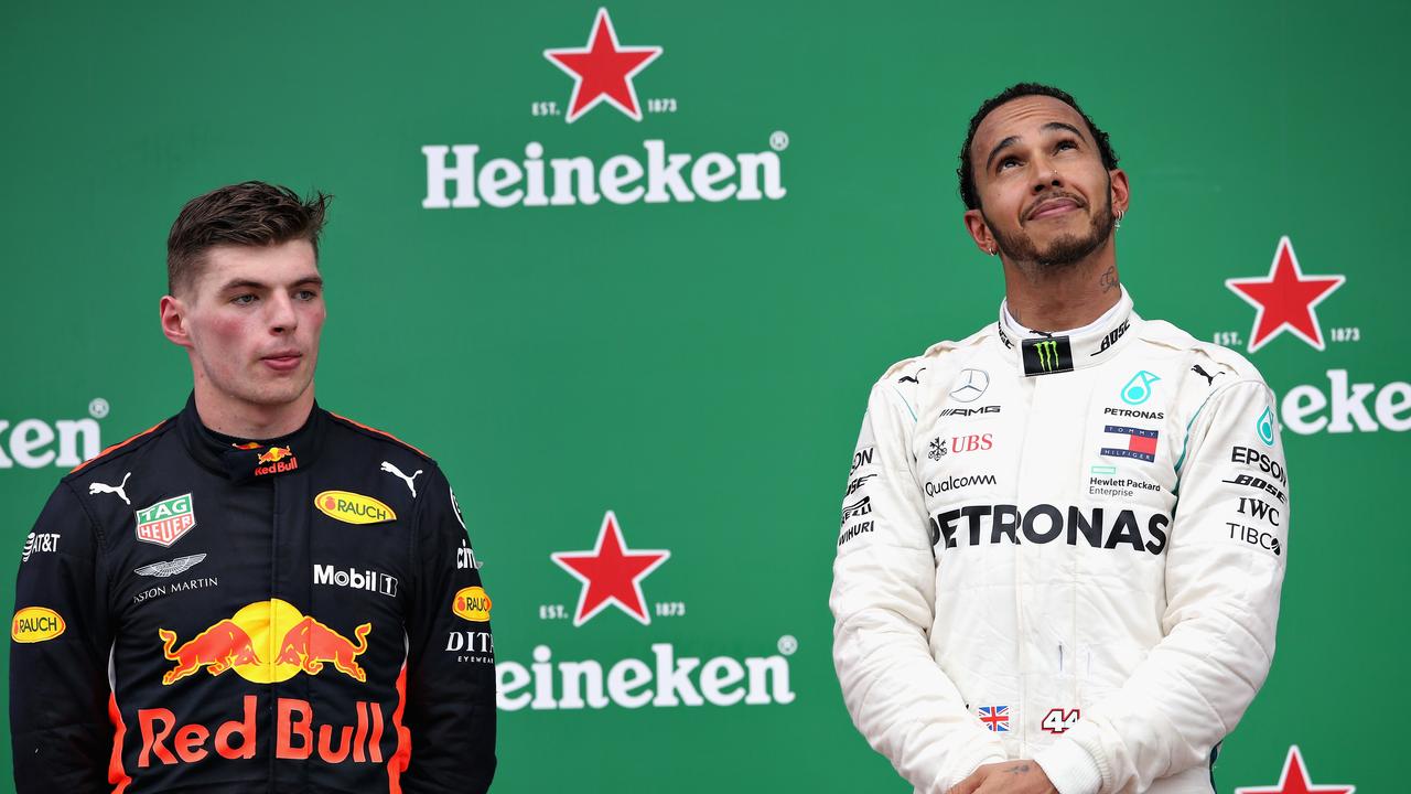 Lewis Hamilton on the Brazil GP podium in 2018 beside Red Bull youngster Max Verstappen.