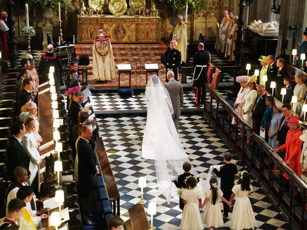 The then Prince Charles proudly walked his daughter-in-law down the aisle in an emotional moment. Picture: AFP