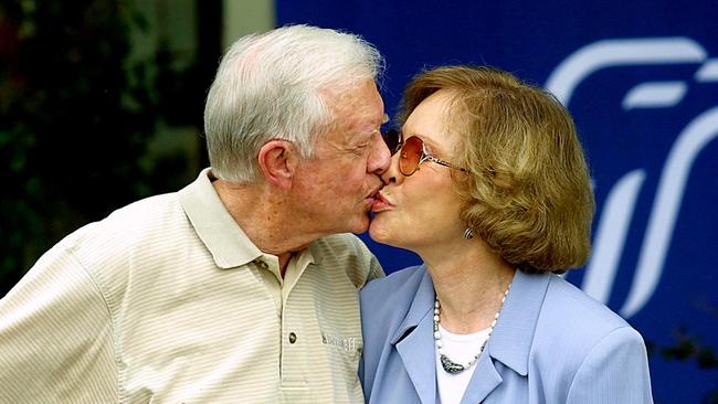 Former US president Jimmy Carter receives a kiss from his wife Rosalynn Carter, who died in 2023 aged 96, after a press conference in Plains, Georgia, in 2002. Picture: AFP