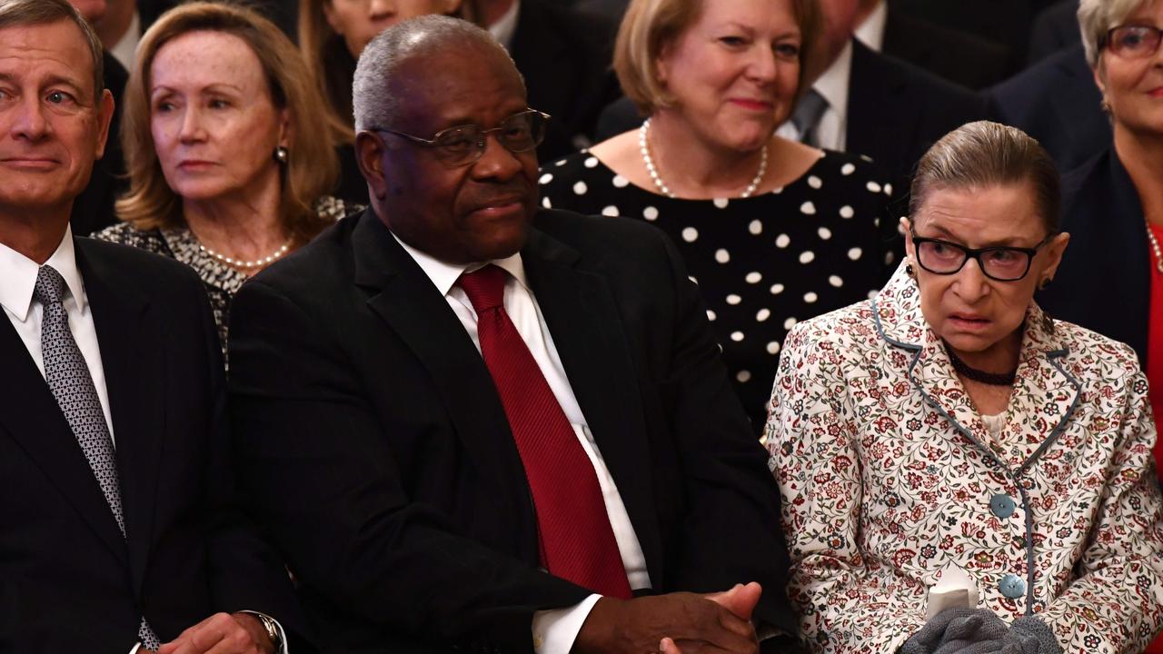 Chief Justice of the US Supreme Court John Roberts and Associate Justices Clarence Thomas and Ruth Bader Ginsburg attend the swearing-in ceremony of Brett Kavanaugh as Associate Justice. Picture: Brendan Smialowski/AFP