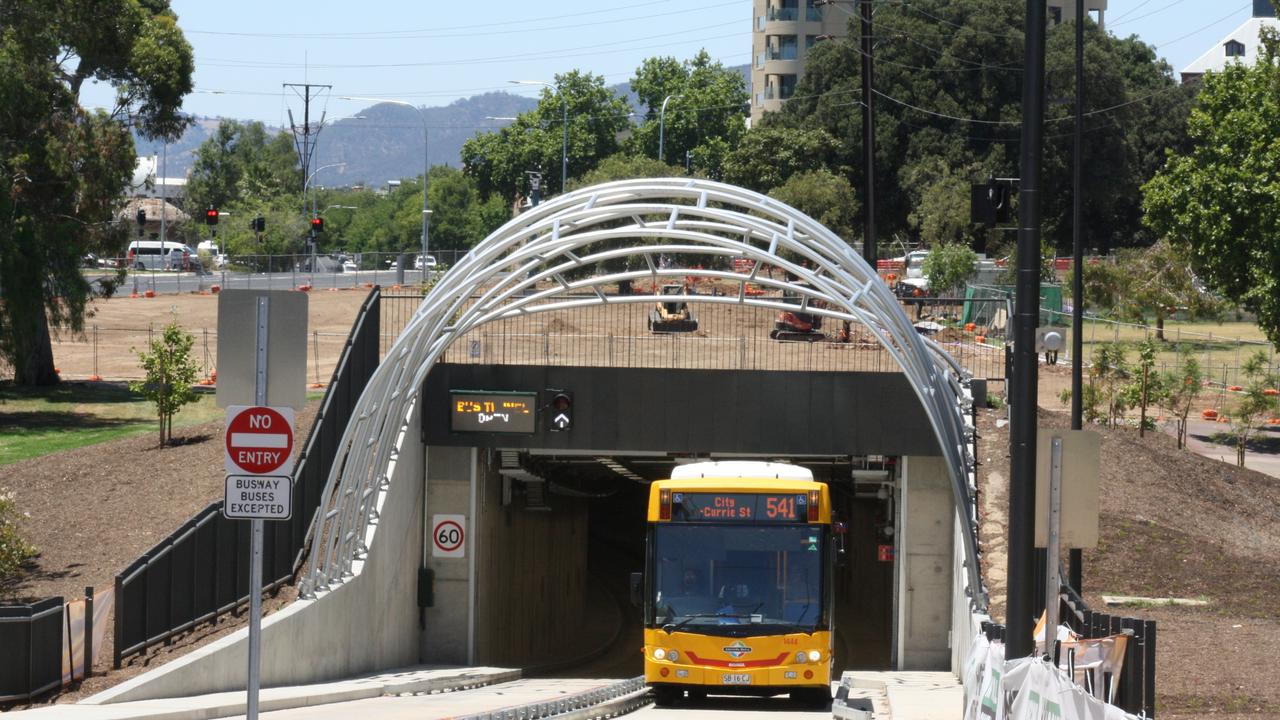 A bus leaves the O-Bahn tunnel under the Adelaide Parklands before it enters Grenfell St in the city.