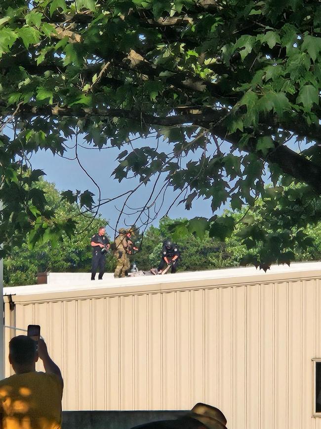 In a picture taken from X, police are seen on a rooftop near the Trump rally in Butler, Pennsylvania where the former president survived an attempted assassination attempt.