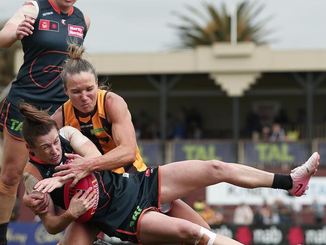 MELBOURNE, AUSTRALIA - OCTOBER 19: Alicia Eva of the Giants is tackled by Emily Bates of the Hawks during the round eight AFLW match between Hawthorn Hawks and Greater Western Sydney Giants at Kinetic Stadium, on October 19, 2024, in Melbourne, Australia. (Photo by Daniel Pockett/Getty Images)