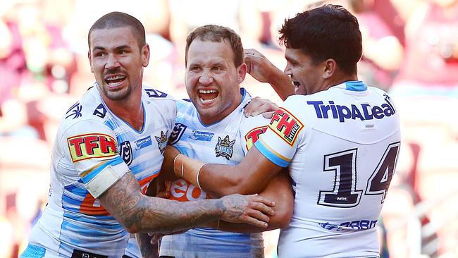 Tyrone Roberts (middle) celebrates a try with Nathan Peats and Tyrone Peachey. Picture: Jono Searle/Getty Images