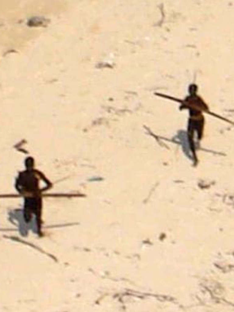 Tribe members hurl spears at a helicopter as authorities fly over North Sentinel Island to assess damage after the 2004 tsunami. Picture: Indian Coast Guard