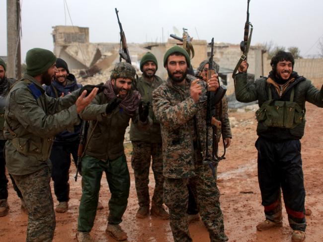 Syrian government soldiers celebrate after taking control of the village of Ratian, north of the embattled city of Aleppo, from rebel fighters on February 6. Picture: George Ourfalian