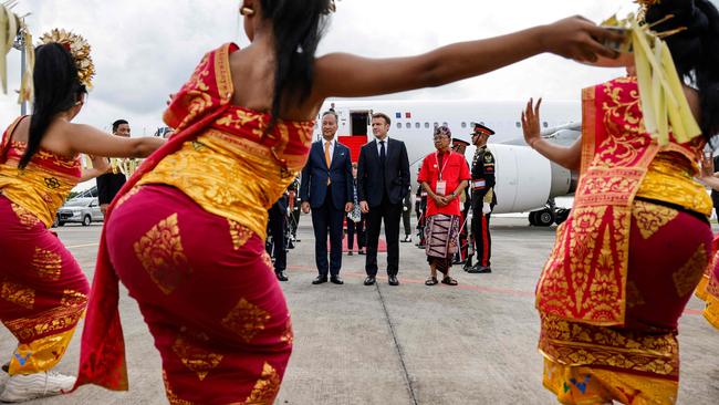 French President Emmanuel Macron, centre, arrives in Bali on Monday. Picture: AFP