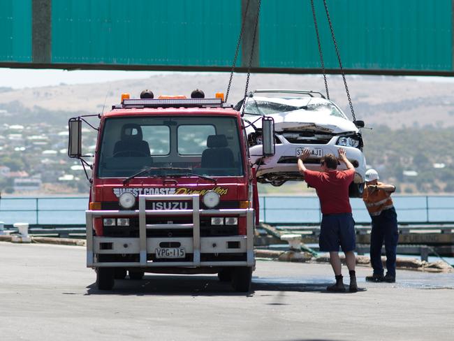 The car is loaded on to a truck to be removed from the wharf. Picture: Robert Lang