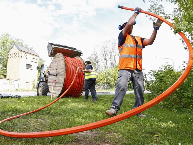 Workers unspool high-speed internet cable in eastern Germany. MICHAELA REHLE/BLOOMBERG NEWS