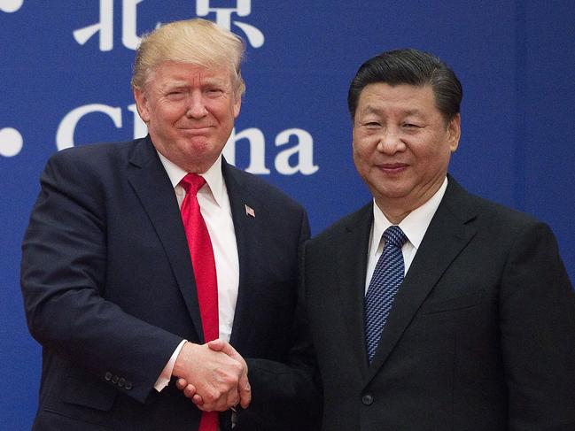 US President Donald Trump and China's President Xi Jinping shake hands during a business leaders event at the Great Hall of the People in Beijing. Picture: AFP