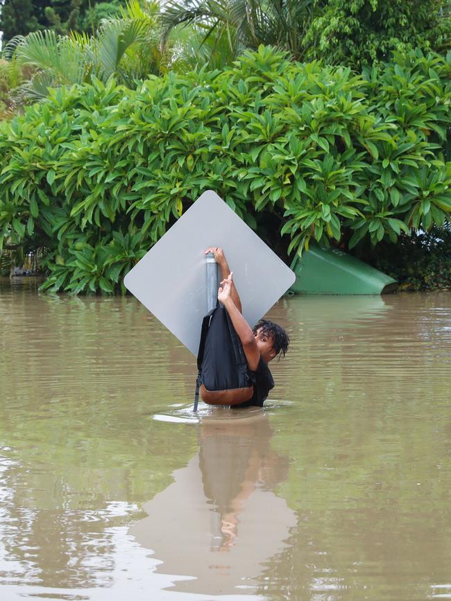 14-year-old Danton Smith was rescued while riding his scooter through 1.8m crocodile invested floodwaters by police diving unit officers. Picture: Michael Chambers