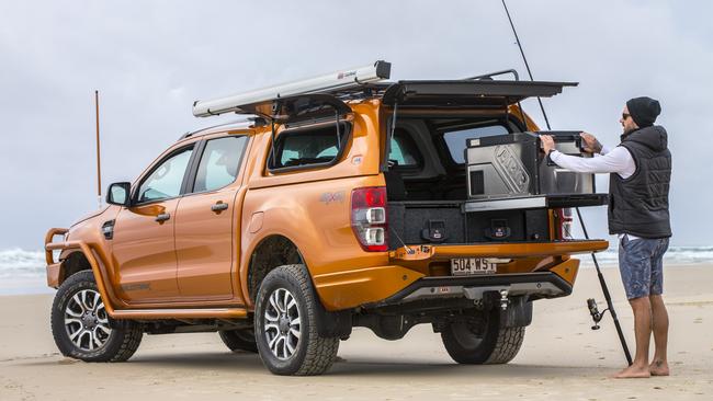 A four-wheel-drive enthusiast enjoys some beach fishing. Generic image.