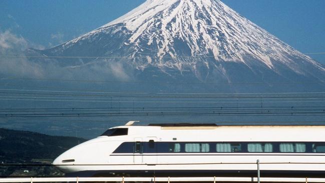 A Bullet train railway in front of Mount Fuji, Japan.