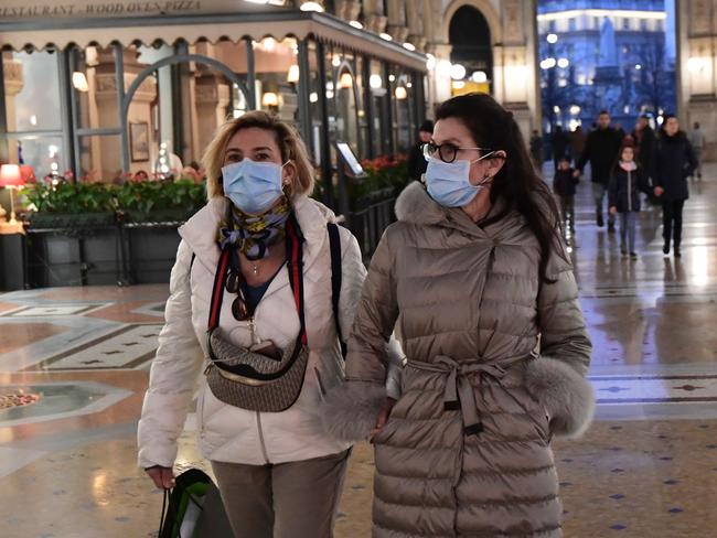 Women wear protective face masks while visiting the Gallery Vittorio Emanuele II, close to the Piazza del Duomo in central Milan, following security measures taken in northern Italy against the coronavirus. Picture: AFP