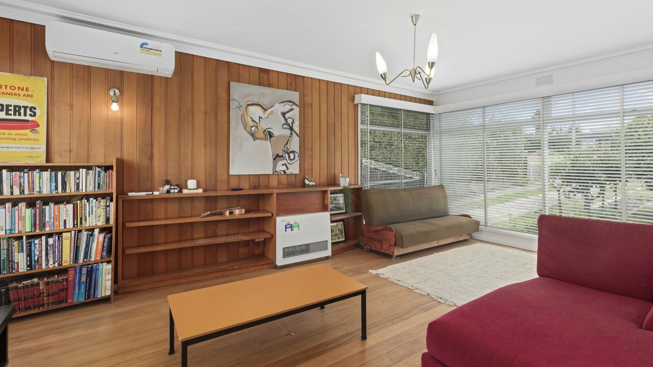 Modern comforts like split system heating and cooling have been installed, alongside sympathetic mid-century light fitting.