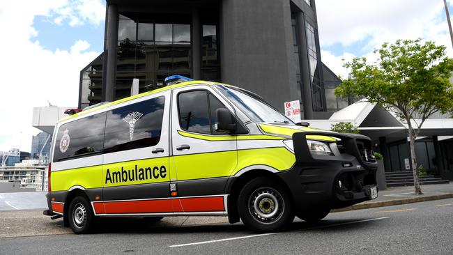 BRISBANE, AUSTRALIA - NewsWire Photos - JANUARY 13, 2021.An Ambulance leaves the Hotel Grand Chancellor in Spring Hill, Brisbane. Guests will be evacuated after six people linked to the building tested positive to the highly-contagious UK variant of the coronavirus.Picture: NCA NewsWire / Dan Peled