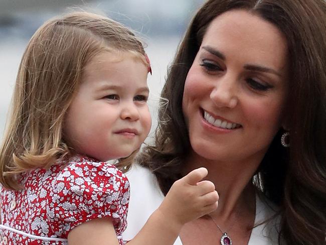 WARSAW, POLAND - JULY 17:  Catherine, Duchess of Cambridge carries Princess Charlotte of Cambridge as they arrive with Prince William, Duke of Cambridge and Prince George of Cambridge on day 1 of their offical visit to Poland on July 17, 2017 in Warsaw, Poland.  (Photo by Chris Jackson/Getty Images)