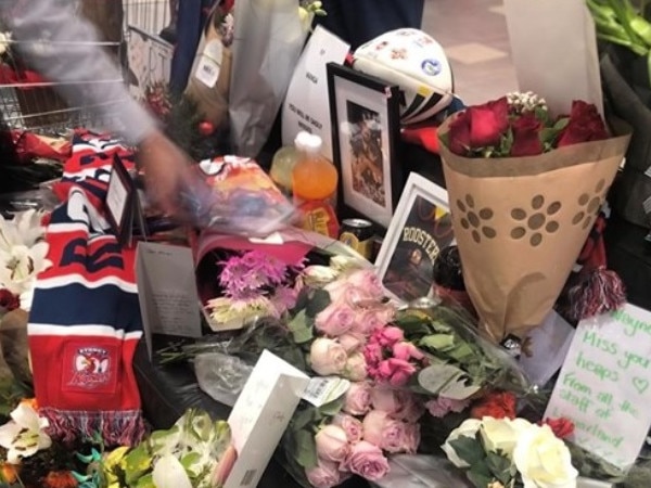 Flowers and other tributes to Wayne 'Wanga' Howard at Lake Haven shops.