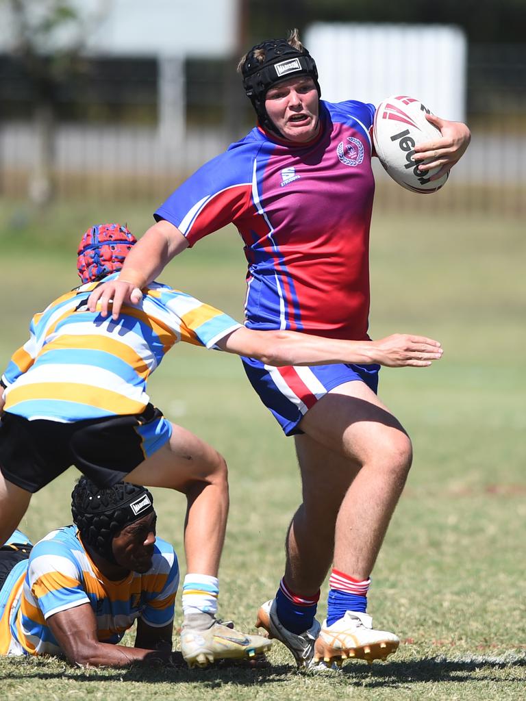 Boys Rugby League State Championship held at Northern Division, Brothers Leagues ground, Townsville. 16-18 years. Peninsula (stripe) v Darling Downs (blue/purple). Thomas Fenwick of Toowoomba Grammar School.