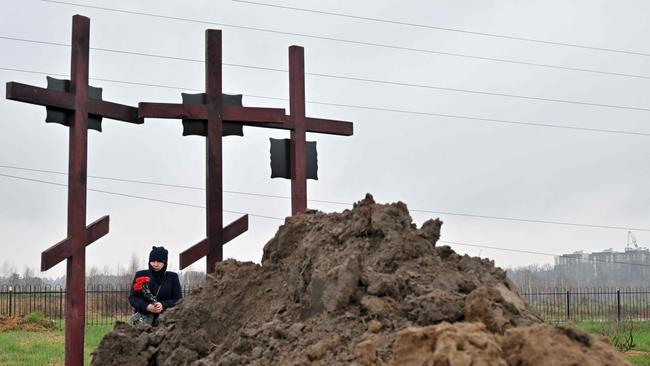 A mourner attends the funeral of a family of three in Bucha, who were reportedly killed by Russian troops as they tried to escape the city. Picture: AFP.