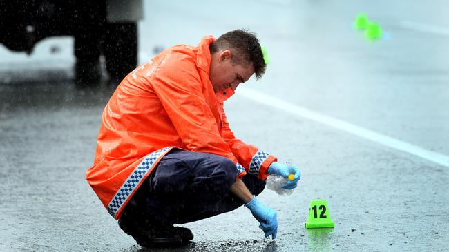 Police examine the road after Omega Ruston was fatally shot on the Gold Coast Highway at Burleigh Heads.