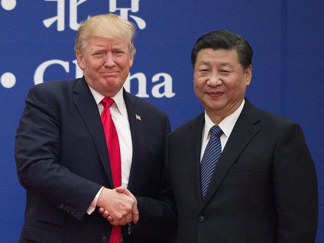 (FILES) In this file photo taken on November 8, 2017 US President Donald Trump (L) and China's President Xi Jinping shakE hands during a business leaders event at the Great Hall of the People in Beijing. - US President Donald Trump, who is seeking reelection on November 3, has regularly jolted the world with statements about other leaders that sharply deviate from long-held diplomatic protocol. (Photo by Nicolas ASFOURI / AFP) / TO GO WITH US-vote-diplomacy-trade-China,FOCUS by Patrick Baert