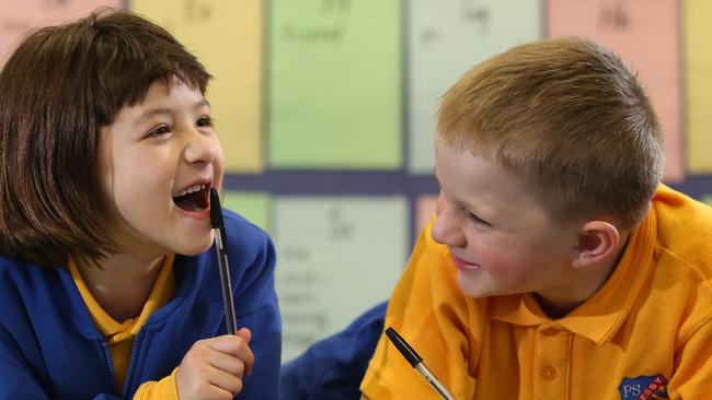 Revesby Public School students Amy Grijak and Riley Patterson enjoy being pen pals. Picture: Robert Pozo