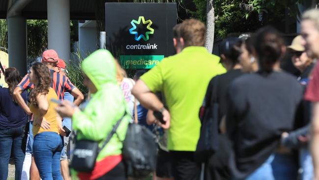 Lines of people wait at Southport Centrelink. Picture: Adam Head