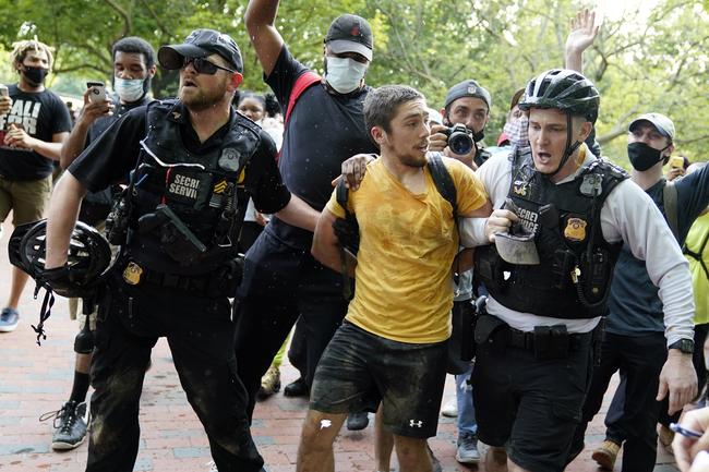 Uniformed US Secret Service police detain a protester in Lafayette Park across from the White House. Picture: AP