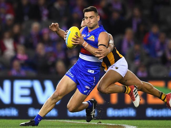 Luke Dahlhaus of the Bulldogs is tackled by Jarman Impey of the Hawks during the round 16 AFL match between the Western Bulldogs and the Hawthorn Hawks at Etihad Stadium on July 7, 2018 in Melbourne, Australia. Picture: Quinn Rooney, Getty Images.