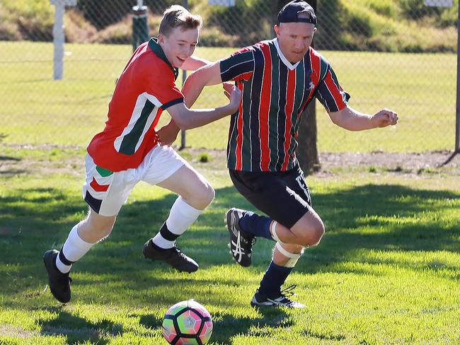 Brendan Ford and Blake Joyner fight for possession.