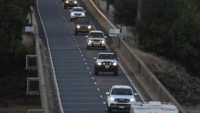 A convoy of vehicles exits Corryong to escape the fires. Picture: Tony Gough