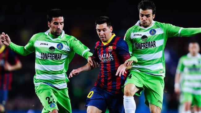 Pedro Leon, right, of Getafe CF, takes on superstar Lionel Messi of FC Barcelona, with help from Juan Rodriguez. Big brother is very proud. Picture: David Ramos (Getty Images)