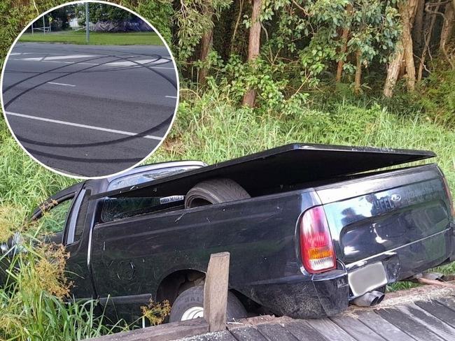 The black Ford ute abandoned in a ditch off McKinnon Drive, Tewantin, after crashing into a pedestrian bridge during suspected hooning. Photo: Paul Garratt.