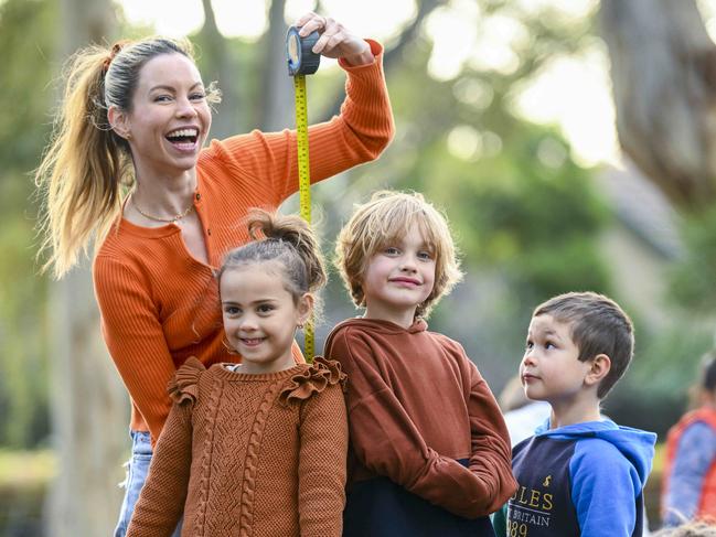 Emily Griffiths-Jones checks the height of Mia Swiecinski ,5, her son Lenny Jones,5, and George Lingley also 5 at Halewood Park Friday,July,7,2023.Picture Mark Brake