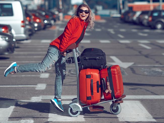 lifestyle shot of happy woman carrying her luggages, laughing and feeling great in her vacation.credit: istockescapeopinion4 april 2021