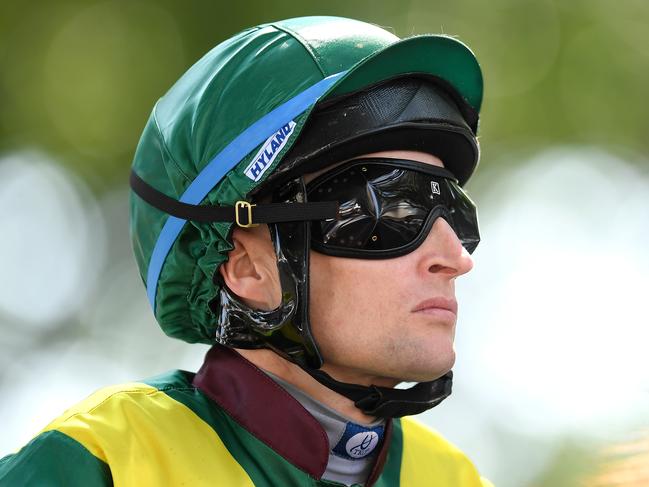 Jockey Craig Newitt makes his way to the start before race 4, the Class 3 Plate, during Metro Races at Eagle Farm Racecourse in Brisbane, Saturday, December 14, 2019. (AAP Image/Albert Perez) NO ARCHIVING, EDITORIAL USE ONLY