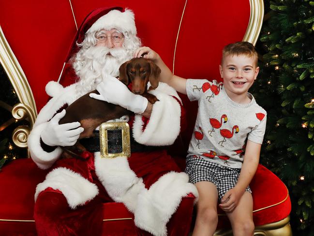 Santa with Finn and his pet dachshund Laurent. Picture: Rohan Kelly