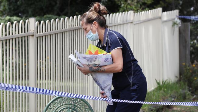 People pace flowers at the house in Tullamarine.