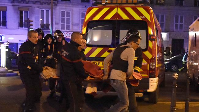 Rescuers evacuate victims near the Bataclan concert hall in Paris last November.