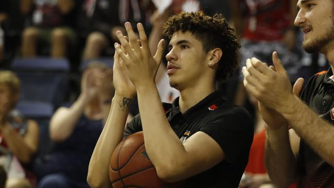 LaMelo Ball cheers on his teammates during his stint on the sidelines with injury.