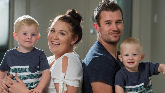 Bailey, left with mum Natalie Reynolds, had a stroke in his first day of life. His twin Beau, right, held by dad Tim Clarkson. Picture: Jay Town