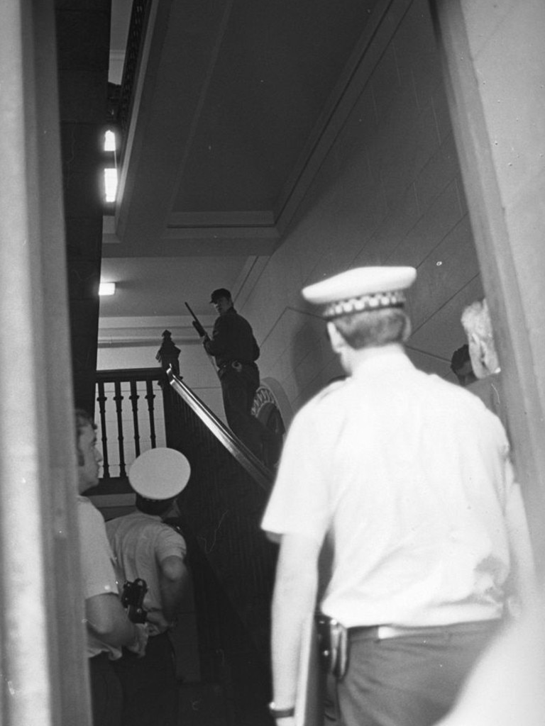 Special Operations Group members and police search the court building after the shooting.